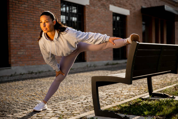 istock Young woman stretching during training in the urban environment 1312934734