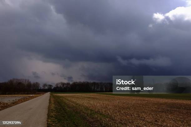 Dirt Road With Fields And Dark Rain Clouds Stock Photo - Download Image Now - Color Image, Day, Dirty
