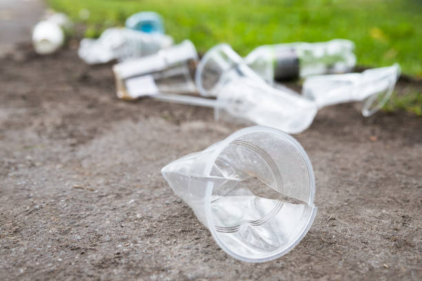 Heap of rubbish on the path, closeup. Empty used plastic cups and plastic bottles Heap of rubbish on the path, closeup. Empty used plastic cups and plastic bottles on blurred background, selective focus.Environmental pollution littering stock pictures, royalty-free photos & images