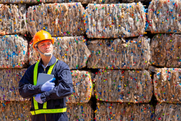 istock Engineer recycle and Environment concept. Engineers standing in recycling center. Male foreman wearing protective equipments and holding tablet. 1312941468