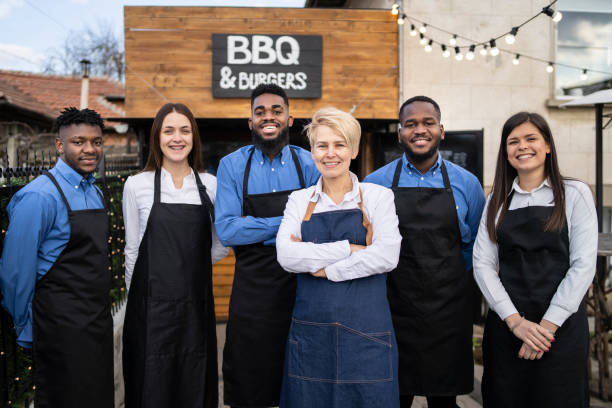 istock Restaurant workers standing outside their restaruant 1312943612