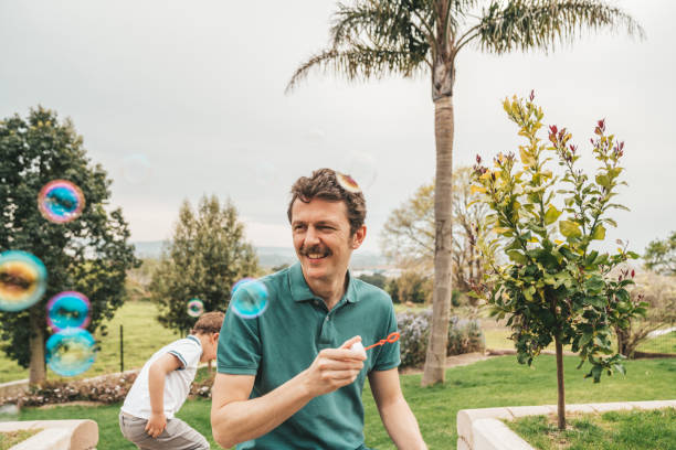 istock Family making bubbles at the garden 1312943813