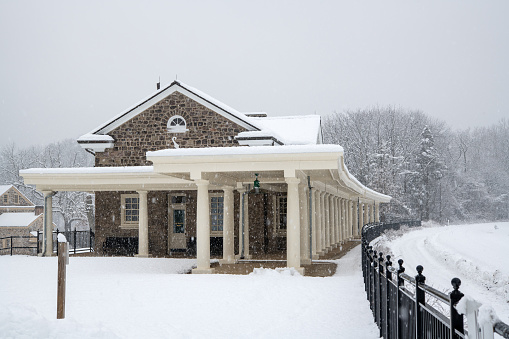 King of Prussia, USA - February 7, 2021. Historic train station at Washington Headquarters in Valley Forge National Historic Park during snowstorm, Pennsylvania.