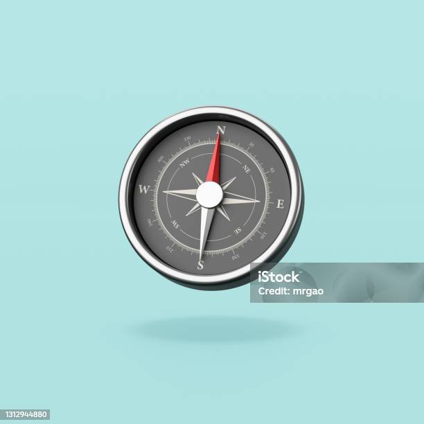 Metallic Compass On Blue Background Stock Photo - Download Image Now - Navigational Compass, Digitally Generated Image, Aiming