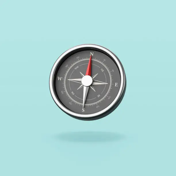Metallic Compass with Red Magnetic Needle Pointing Toward the North Isolated on Flat Blue Background with Shadow 3D Illustration