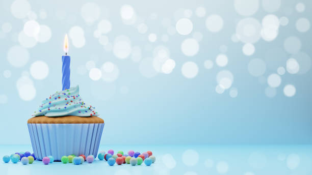 istock Festive cupcake with candle on blue background with bokeh, 3d rendering. 1312946635