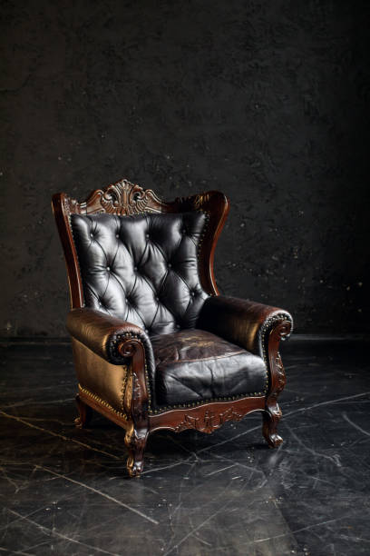 istock Black genuine leather classical style sofa in black room. Modern interior. Loft 1312947623