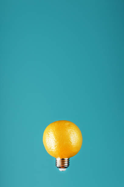 istock Lemon as a light bulb in levitation on a blue background. The conceptual idea 1312951178