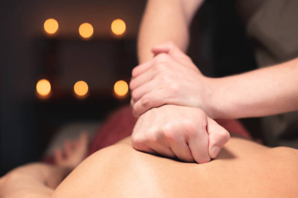istock male masseur with his hands kneading muscles on his back, close-up 1312952461