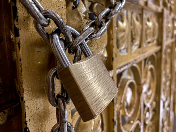 istock padlock and chains closing ornamental door 1312956783