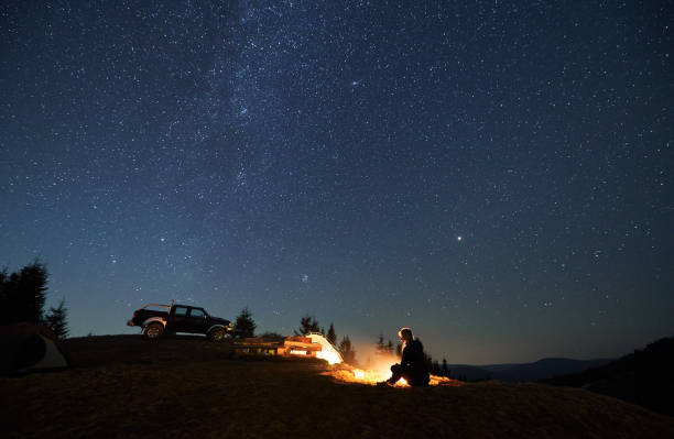 istock Recreation in campsite in the mountains at starry night. 1312962928