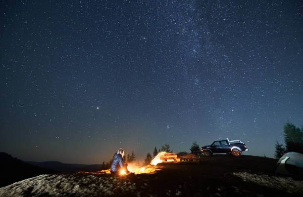 istock Recreation in campsite in the mountains at starry night. 1312962935