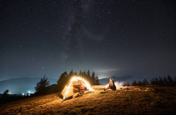 istock Romantic nightly camping in mountains under starfull sky. 1312962953