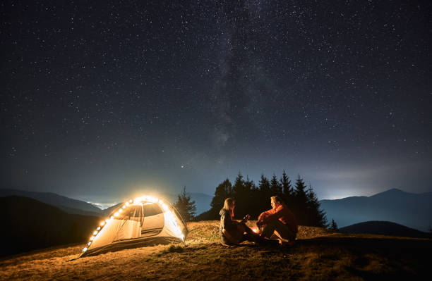 istock Romantic nightly camping in mountains under starfull sky. 1312962954
