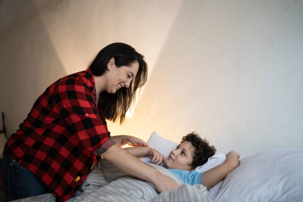 istock Mother putting son to sleep at home 1312968994