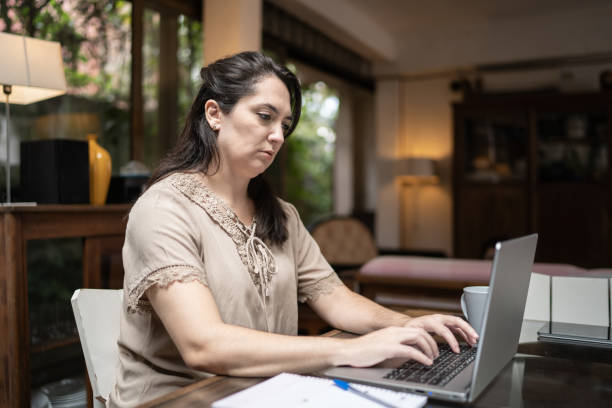 istock Woman using laptop working at home 1312969840