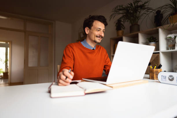 istock Smiling young businessman working at home 1312972515