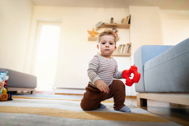istock Baby boy trying to stand up by himself 1312976789