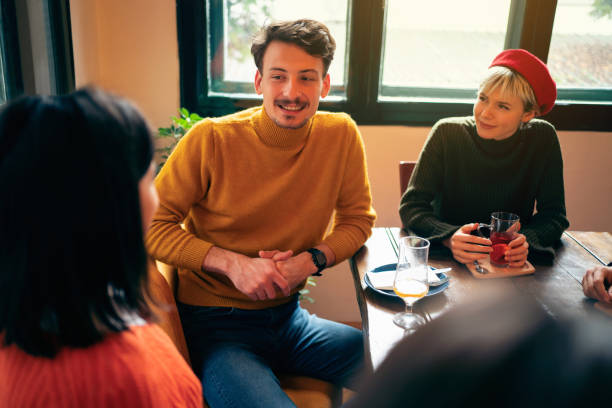 istock Cheerful colleagues sitting in a restaurant and discussing 1312978110
