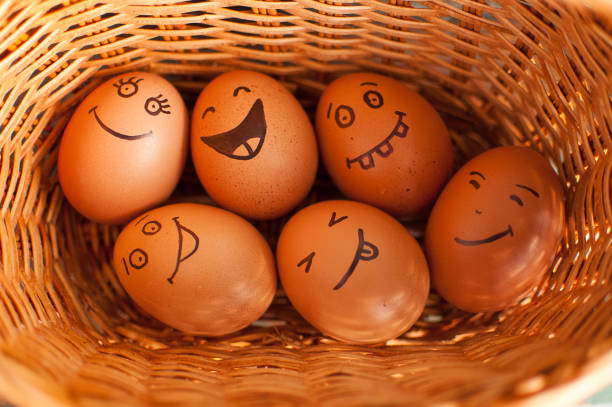 istock Stack of eggs with hand drawn faces on straw basket, easter preparation, holiday mood concepts 1312978142