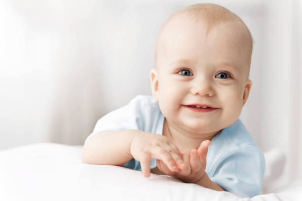 istock Smiling baby on the bed 1312979089