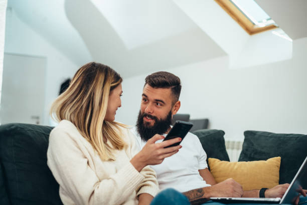 istock Couple using a laptop and a smartphone at home 1312979598