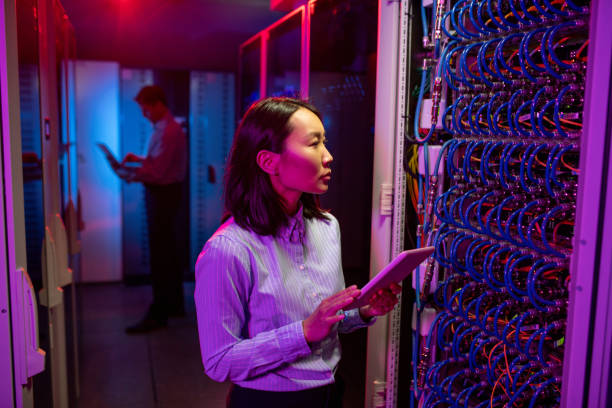 istock Asian woman maintaining network in server room 1312980193