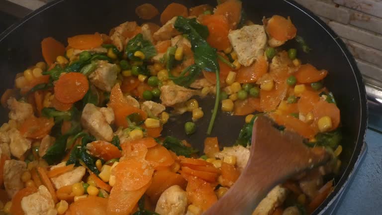 Opening frying pan full of vegetables, preparing asian meal