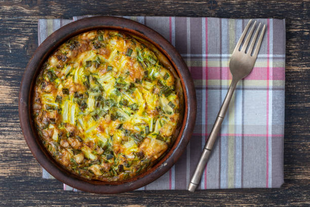 istock Ceramic bowl with vegetable frittata, simple vegetarian food. Frittata with egg, pepper, green onions and cheese . Healthy egg omelet 1312980729