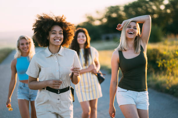 istock Four friends walking on a country road 1312981659