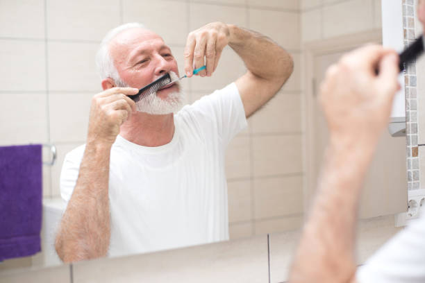 istock Senior man cutting beard in the bathroom 1312982423
