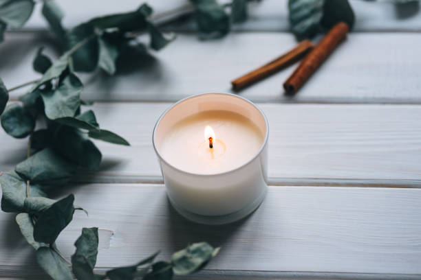 istock Candle, eucalyptus, cinnamon  on white wooden background 1312985500