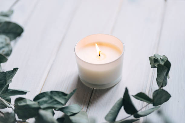 istock Candle, eucalyptus on white wooden background 1312985504