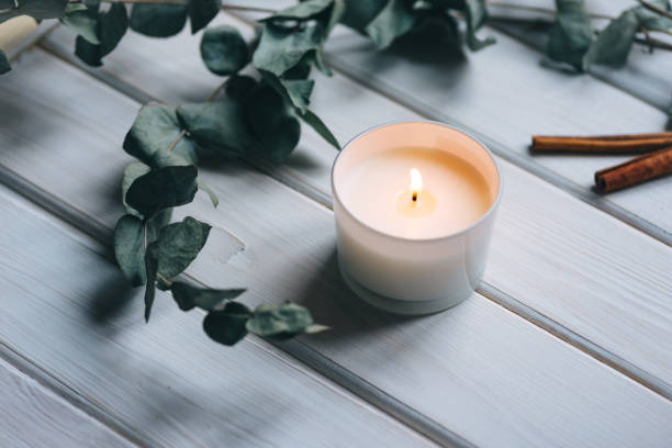 istock Candle, eucalyptus, cinnamon on white wooden background 1312985508