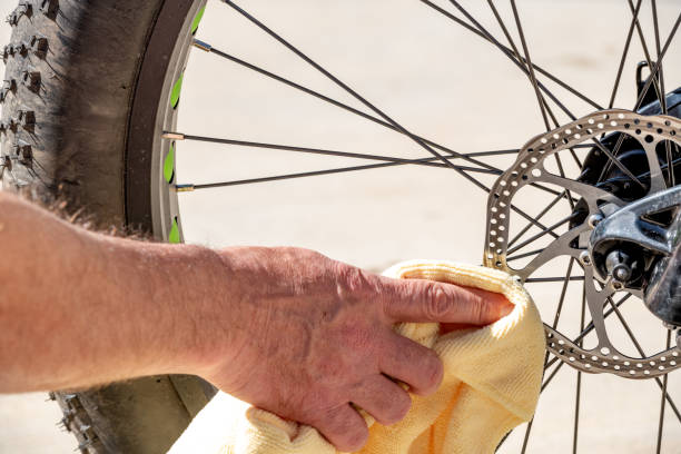 istock Mechanic uses a microfiber cloth to clean off bike disk breaks 1312986424