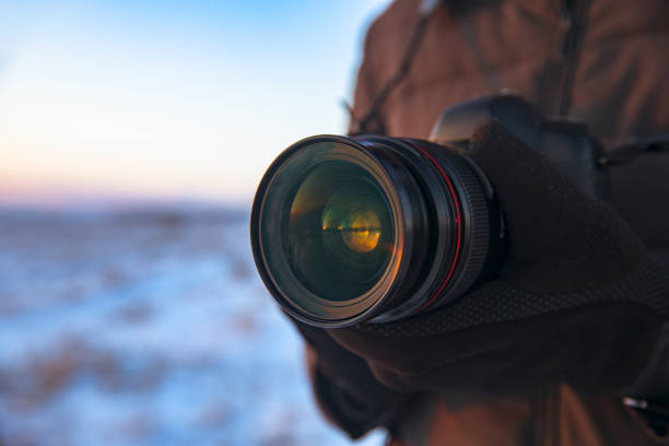 istock man holding camera in winter nature 1312986808
