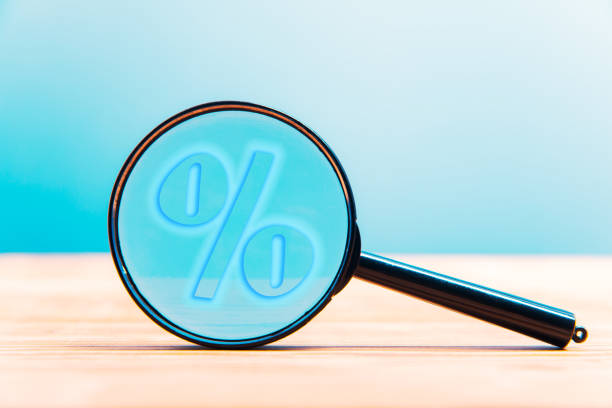 istock Magnifying glass with a percent sign 1312986810