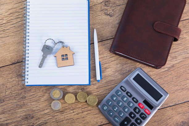 istock house key on notepad with coins and calculator 1312986840
