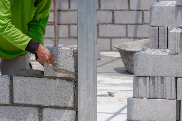 istock Cropped image of bricklayer making interior brick wall inside of house construction site 1312988804