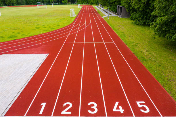istock perspective view of an open - air stadium with red numbered running tracks 1312989075