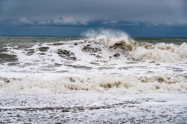 istock White waves, sea horizon and cloudy sky with clouds 1312990005