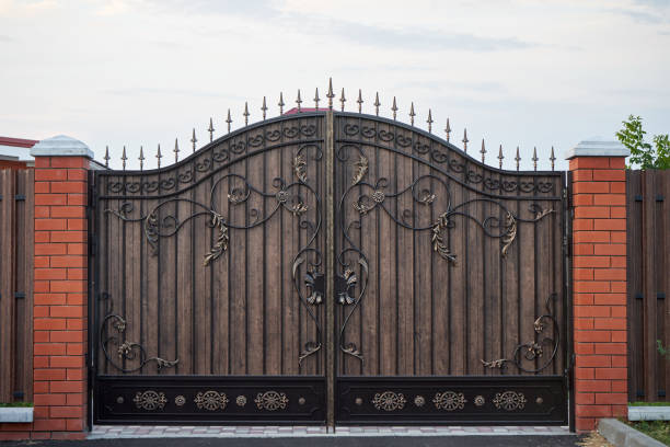 istock New metal wrought black gates with ornate elements 1312991457