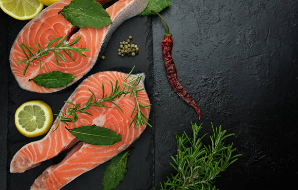 istock Fresh uncooked fish salmon steaks on a black slate background 1312992118