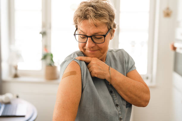 istock Vaccinated woman showing her bandage 1312998115