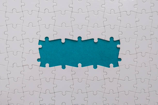 unfinished white jigsaw puzzle - absence part of jigsaw puzzle planning imagens e fotografias de stock