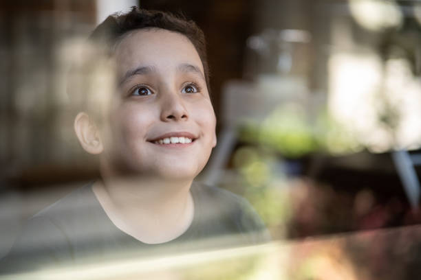 istock Boy contemplating at home 1313000291