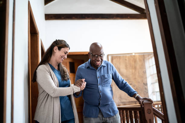 home caregiver helping senior man walking at home - social worker assistance home caregiver community outreach imagens e fotografias de stock