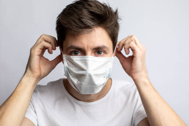 istock a man puts on a medical mask against coronavirus 1313002445
