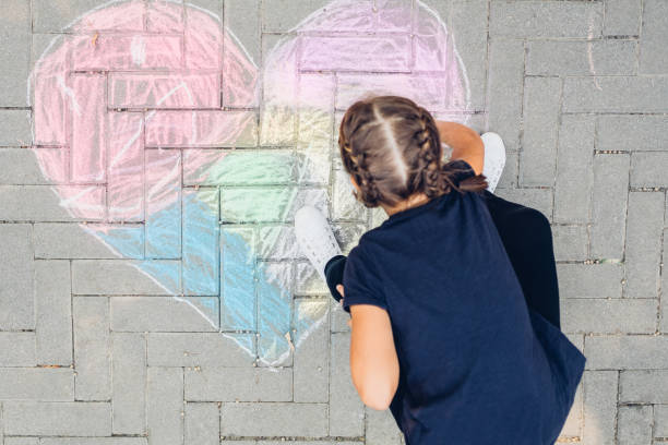 istock Little Girl Draws A Heart 1313004070