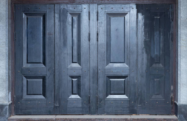 istock A grey and blue wooden street doors. Four doors all together. 1313005331